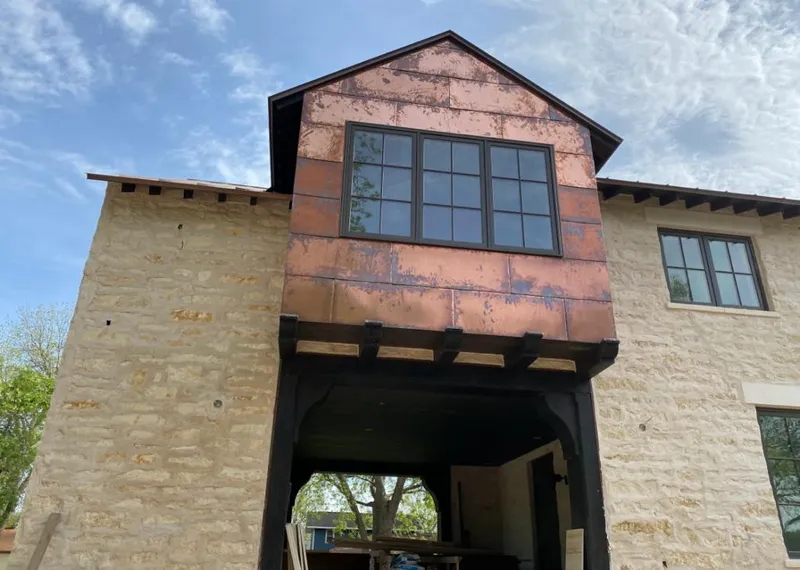 Copper metal panel facade on a stone building for Skylight Installation in Chino